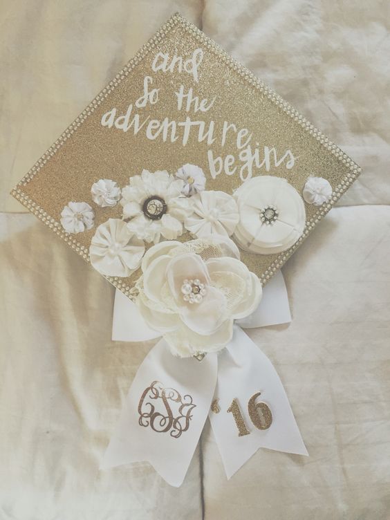 Graduation Cap Decorated With White Faux Flowers and Pearls. 
