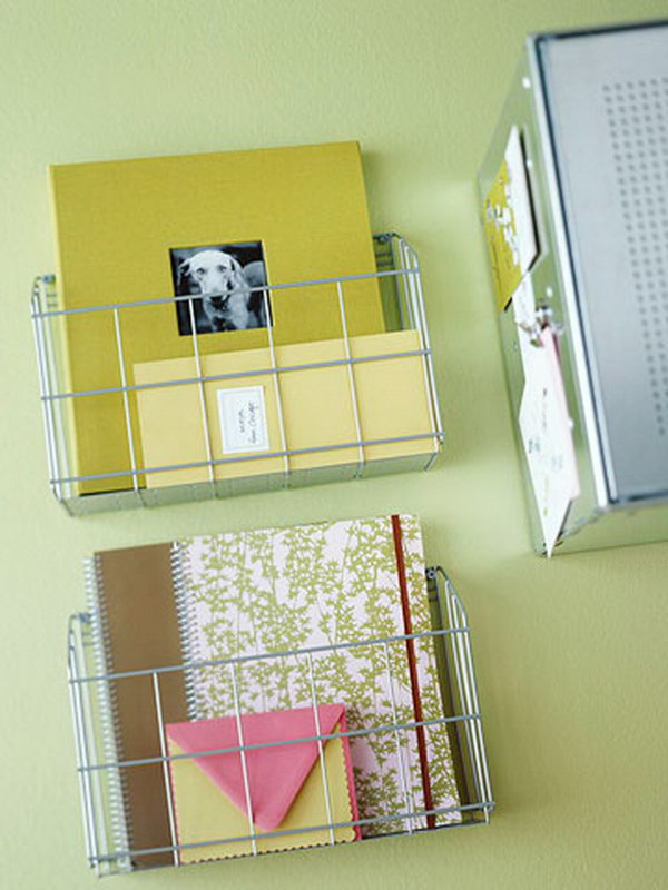 Kitchen wire racks are used in the home office as wall-mounted notebook holders. 