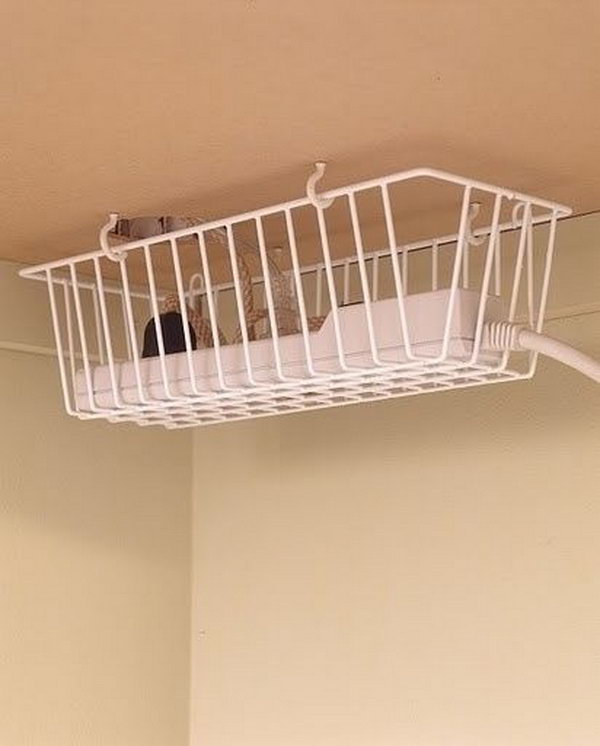 Take advantage of the under desk space by hanging a basket under the desk to keep cords off the floor. 