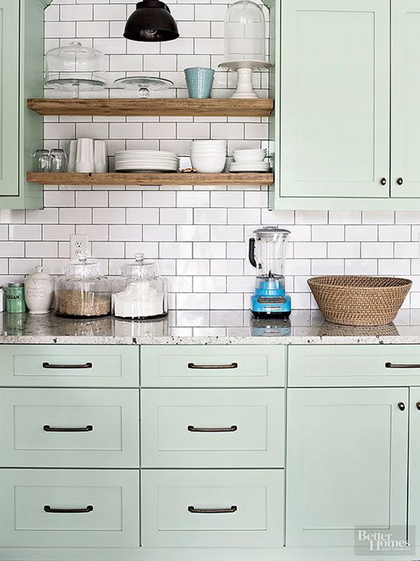 Light Green Painted Kitchen Cabinets with Shiny White Subway Tile Backsplash. 