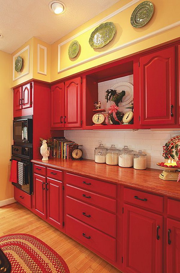 Red Cabinets paired with Pale Yellow Walls and White Subway Tile Backspalsh. 
