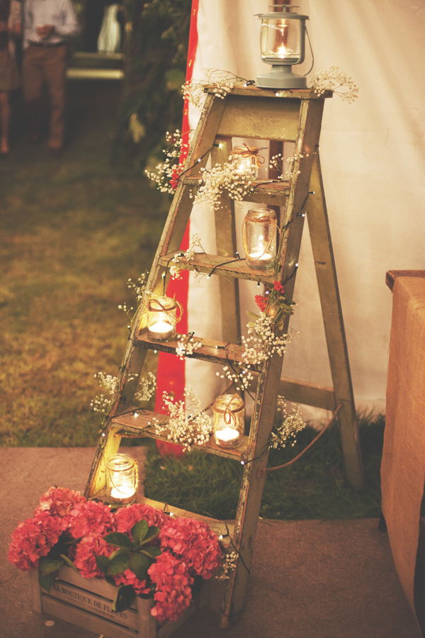 Rustic Ladder Decorated With Mason Jar Lights. 