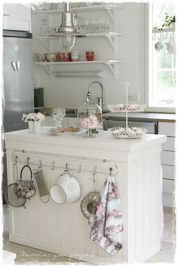 Shabby Chic Kitchen Island with Slightly Mismatched Hooks on One Side. 