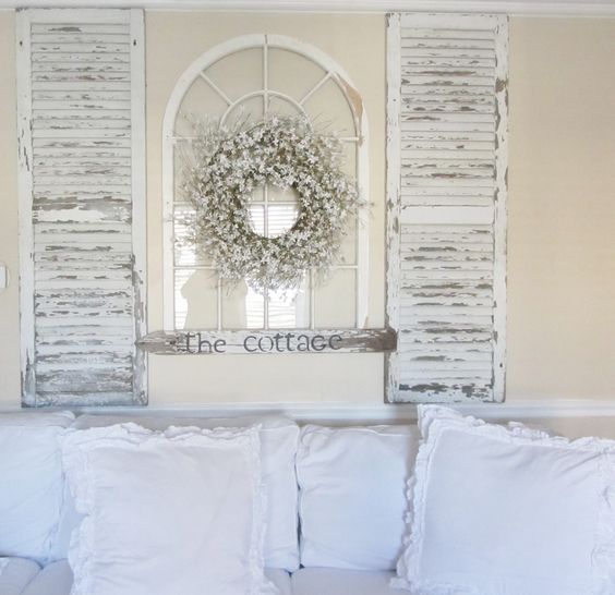 Turn Old Shutters and an Old Arch Window Into a Focal Point Over The Sofa. 