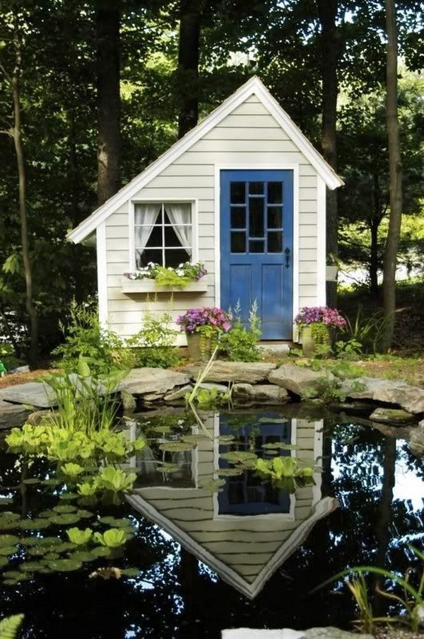 Small folly style cottage shed beside a lake. 