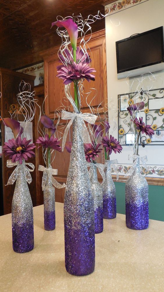 Purple ombre wine bottle vases for centerpieces. 