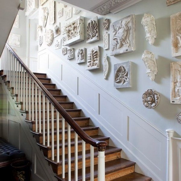 striking sculptures  give this regency-inspired hallway timeless appeal. 