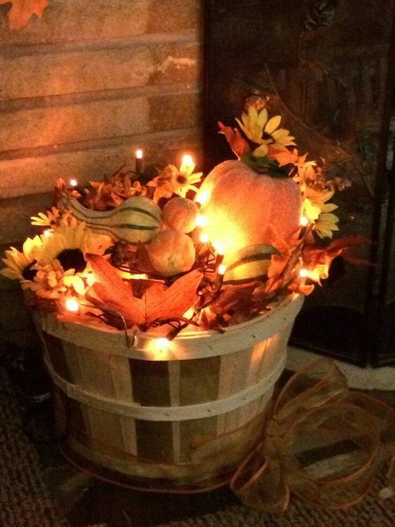Fill a Basket with Leaves and Christmas Lights for Fall Porch Decor. 